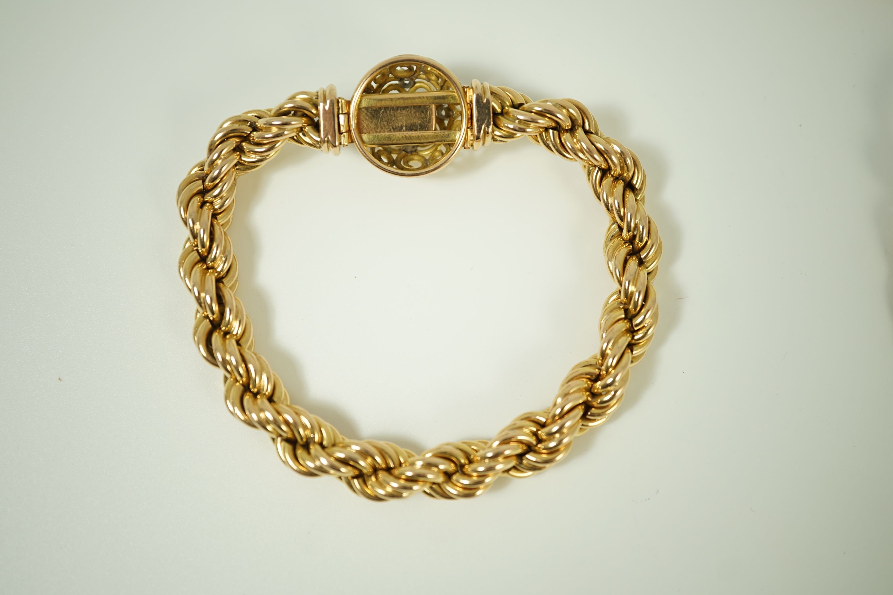 A modern heavy Middle Eastern gold and diamond set rope twist drop tassel necklace, together with a similar gold and diamond set bracelet